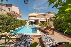 A pool area with lounge chairs and a pergola. - Villa Petra Zadarvillas (Bibinje)