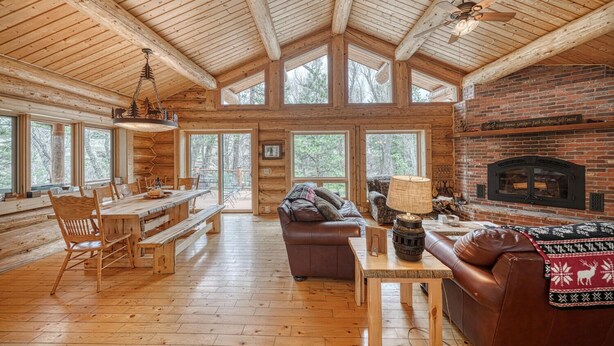 A log cabin interior with a dining area, a fireplace, and a cozy seating area. - Inviting and Relaxing-Cliffs and Streams! (Nathrop)