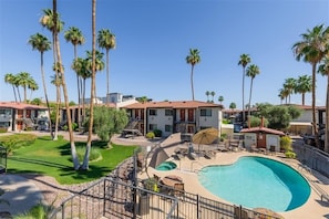 A hotel with a swimming pool, palm trees, and a well-maintained lawn. - 213 Fully Furnished 1BR Suite-Outdoor Pool! by RedAwning (Scottsdale)