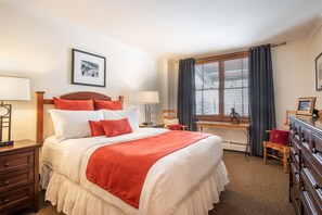 A neatly arranged hotel room with a large bed, a desk, and a chair. - Zephyr Mountain Lodge, Condo | Ski-In/Ski-Out Continental Divide Views (Value-Rated Condo 2202) (Winter Park)