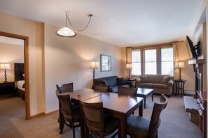 A spacious living room with a dining area, a sofa, and a TV. - Zephyr Mountain Lodge, Condo | Ski-In/Ski-Out Continental Divide Views (Value-Rated Condo 2202) (Winter Park)