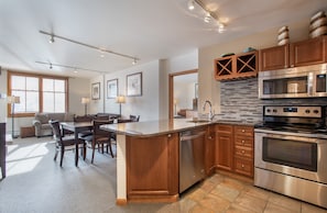 Enjoy meal preparation and dining in this well-equipped kitchen with a central island, double oven, and dining area.