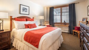 A neatly arranged hotel room with a large bed, a desk, and a chair. - Zephyr Mountain Lodge, Condo | 2 Bedroom (Select-Rated Condo 1315) (Winter Park)