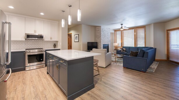 A modern kitchen with stainless steel appliances, a central island, and pendant lighting. - Zephyr Mountain Lodge, Condo , 3 Bedroom (Premium-Rated Condo 2505) (Winter Park)