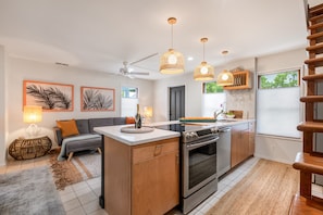 Enjoy cooking in this well-equipped kitchen with a central island, oven, and stovetop.