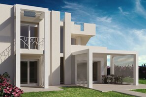 A modern two-story house with a flat roof, large windows, and a covered patio area.