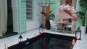 A serene indoor pool area with a clear water surface, surrounded by light green walls and white tiled flooring. - Riad Dar Rabiaa (Rabat)
