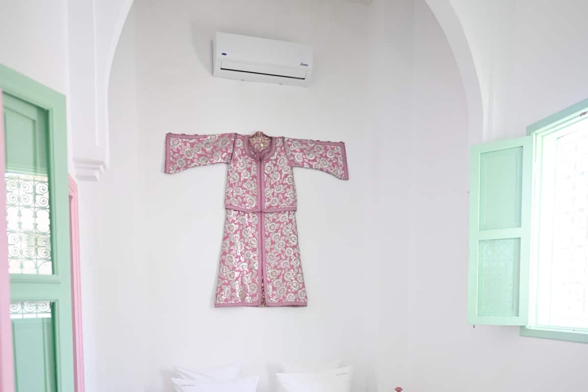 Un dormitorio con cama, mesita de noche, cómoda y ventana.