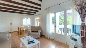 A spacious living room with a sofa, coffee table, and dining area. - 3 Bedroom Villa, Private Pool, Close to the beach, Binibeca (Binibeca)