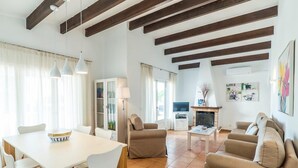 A spacious living area with a dining table, sofas, and a TV. - 3 Bedroom Villa, Private Pool, Close to the beach, Binibeca (Binibeca)