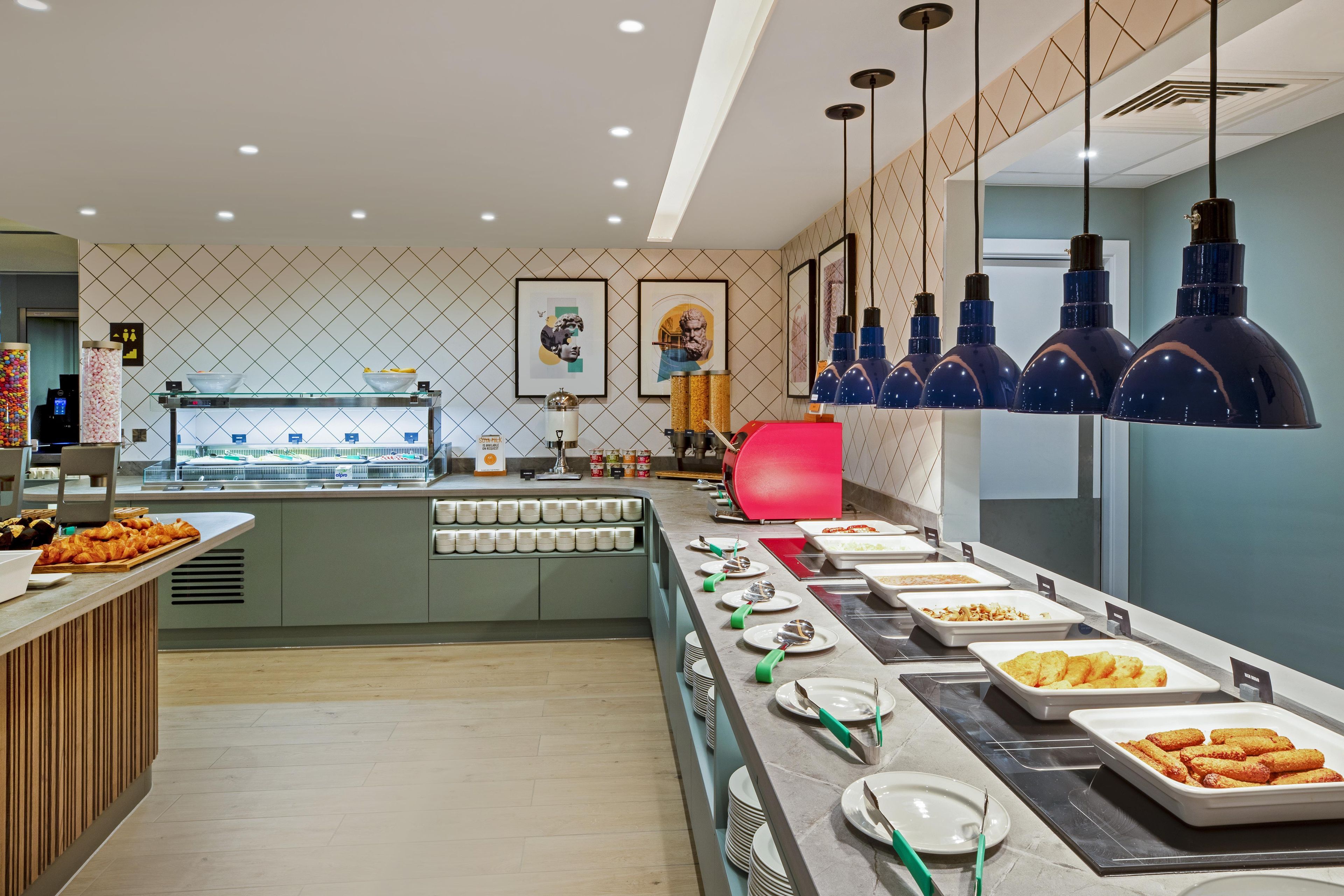 A buffet setup with various food items and serving utensils.
