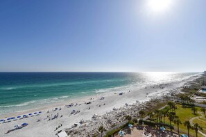 A beach with umbrellas and sun loungers, a clear sky, and the ocean. - 10th Floor 3 Bedroom Condo at Silver Beach Towers (Destin)