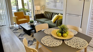A modern living room with a dining table, chairs, a sofa, and a coffee table. - LOCATION! LOCATION! LOCATION!  Best location in Orlando (Orlando)