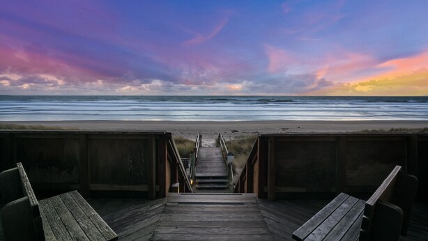 A wooden boardwalk leading to a beach with a sunset view. - Serene & Modern~ Ocean Front View~ 2 Bd 2 Bth~1st Fully Remodeled (Watsonville)