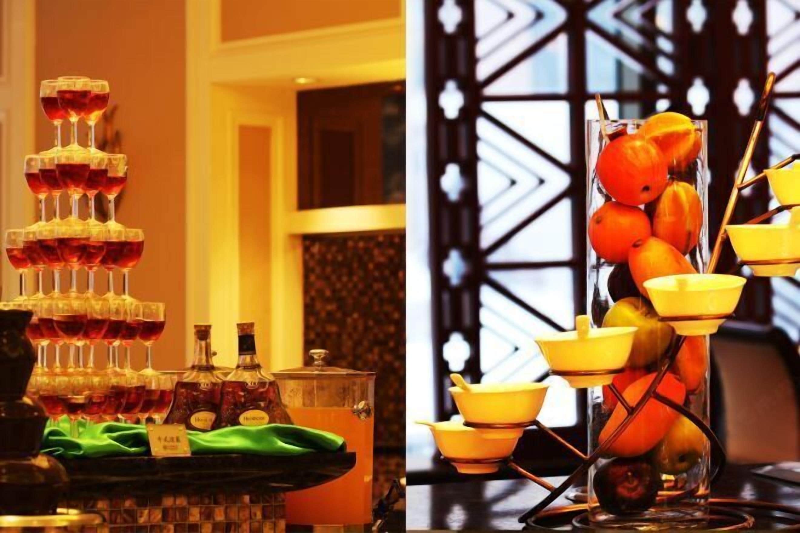A bar area with a tiered drink dispenser and a fruit display.