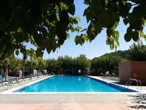 Seasonal outdoor pool, open 11:00 AM to 8:00 PM, pool umbrellas