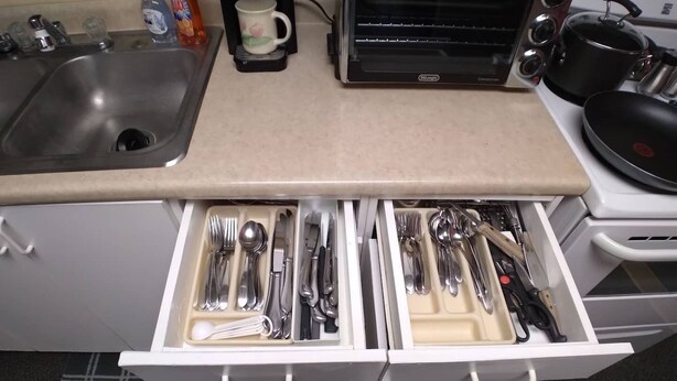 A kitchen with a drawer containing various utensils and a coffee maker on the counter. - All-inclusive Apartment - 1 Bedroom, 1 Bath, Equipped Kitchen, & Laundry (Terre Haute)