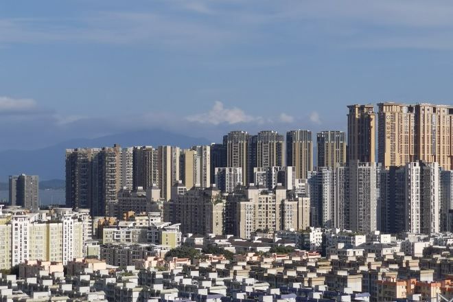 A high-rise residential area with multiple apartment buildings and a dense urban skyline.