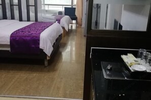 A hotel room with two beds, a small table with a tray, and a mirror. - Shenzhen Four Seasons Family Apartment (Shenzhen)