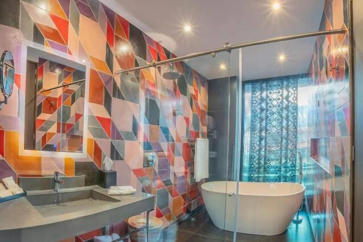 deluxe suite, 1 king bed | bathroom | shower, rainfall showerhead, free toiletries, hair dryer