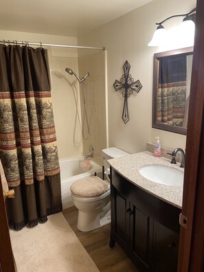 Combined shower/tub, towels, soap, shampoo