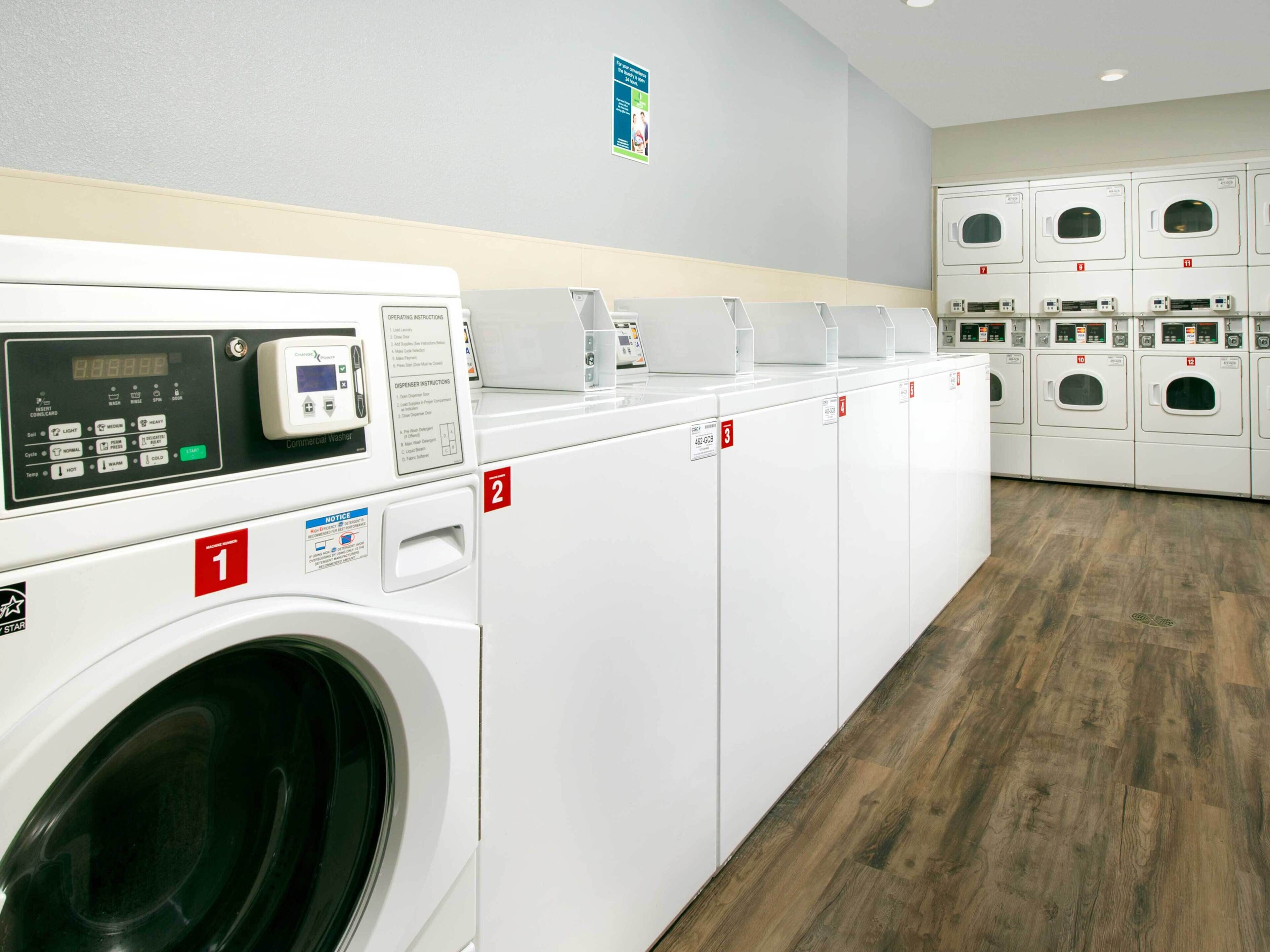 A laundry facility with multiple washing machines, each marked with a number.