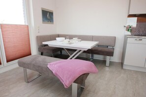 A modern kitchenette with a white countertop, a sink, and a small cabinet. - Bright and open: The homely apartment, which was completed in 2017 (Wittmund)