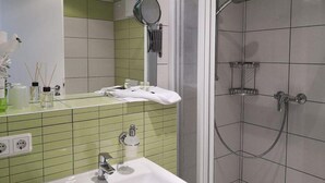 A bathroom with a sink, mirror, and shower. - Comfortable non-smoking apartment Die Remise Marengo RE-11 on Usedom - The (Stolpe auf Usedom)