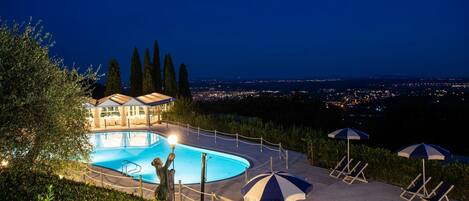 A heated pool, sun loungers