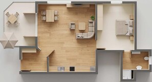 Un plan d’étage d’une chambre d’hôtel comprenant un coin cuisine, un espace repas, un salon avec un canapé et une table basse, et une salle de bain.