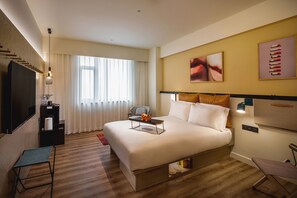 A modern hotel room with a large bed, a flat-screen TV, a desk with a chair, and a window with curtains. - Moxy Xi'An Beilin (Xi'an)