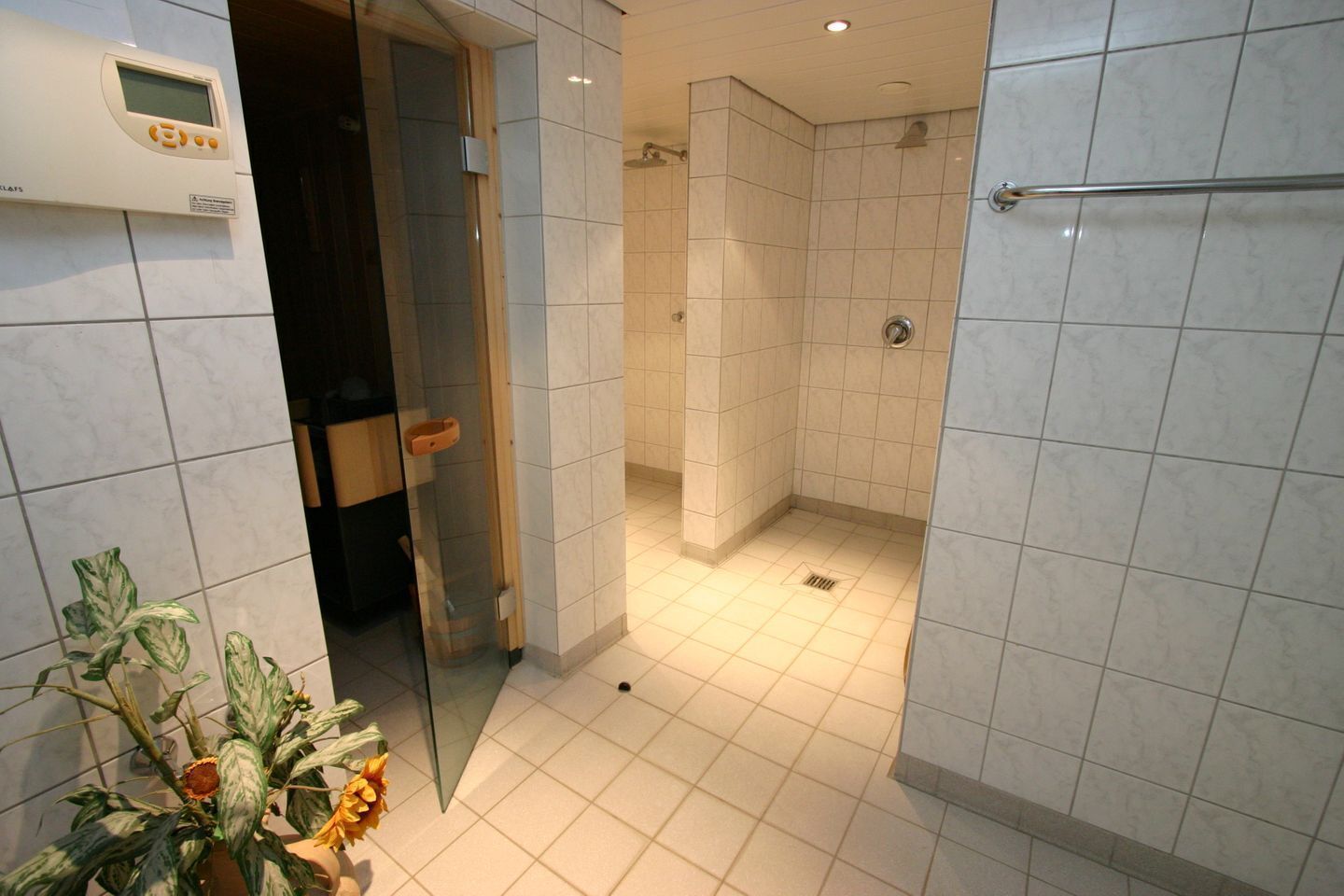 Un baño moderno con zona de ducha, inodoro y lavamanos.