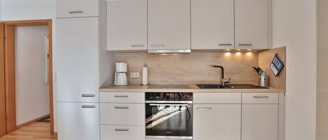 Fridge, stovetop, dishwasher, coffee/tea maker