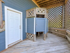 A wooden deck with a door and a blue cabinet. - Goldenberg - 🏄Enjoy Spectacular Views from this 4 BR Oceanfront Home🏄 (Southern Shores)
