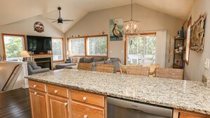 A spacious kitchen with a large island, wooden cabinets, and a Bosch dishwasher. - Luap's Place - Oceanside 5 BR home w/ Private Pool and Hot Tub (Corolla)