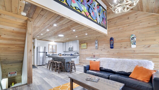 A modern interior with a kitchen, dining area, and living room. - Camelback Cabin 8  Poconos (Tannersville)