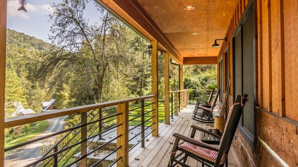 A wooden deck with a railing overlooking a forested area. - A River Mist Walk - Walk to river, pet friendly, hot tub, pool table (Sugar Grove)