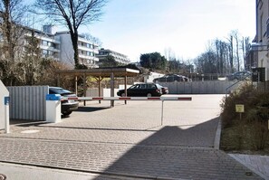A gated entrance to a residential area with a car parked inside.