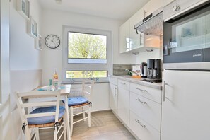 Fridge, stovetop, dishwasher, coffee/tea maker