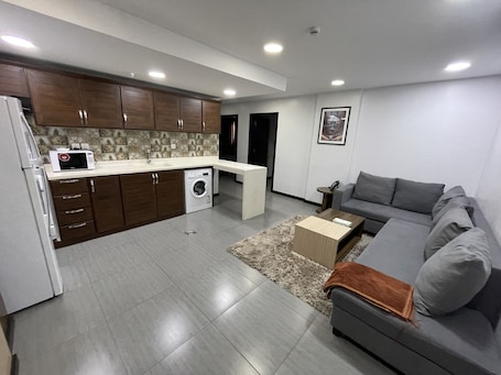 Three Bedroom Apartment | Living area | 55-inch LED TV with satellite channels, TV, fireplace