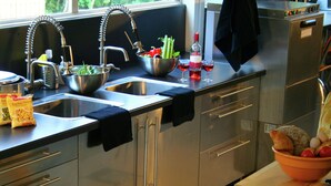 A modern kitchen with stainless steel appliances, a double sink, and a variety of food items on the counter. - Beautiful country house in the Ardennes with lots of privacy (Nisramont-La Roche)