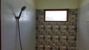 A bathroom with a shower, tiled walls, a window, and a toilet. - Home Stay Muhrodin (Borobudur)