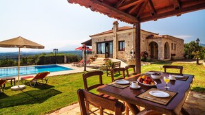 A stone villa with a pool, outdoor dining area, and a view of the mountains. - Traditional Holiday Villa with Panoramic View (Chania)