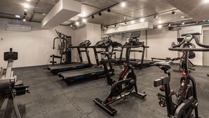 A gym with various exercise equipment including treadmills, stationary bikes, and weight machines. - Air-conditioned Studio 50 m from the Beach | Parking | Gym (Mielno)