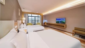 A hotel room with two beds, a TV, a window with a view, and a desk with a lamp. - Ruijiang International Hotel (Sandu)
