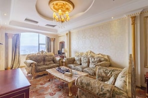 A luxurious living room with ornate furniture, a chandelier, and a large window offering a view. - Yifeng Hotel (Yifeng)