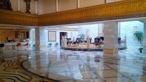 A spacious lobby with a polished marble floor, a central seating area, and a decorative ceiling. - Yifeng Hotel (Yifeng)