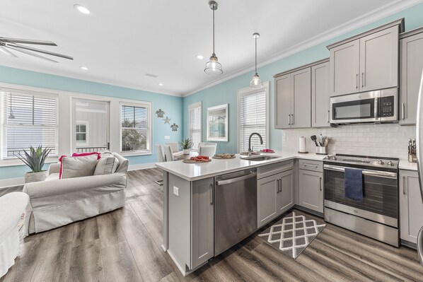 Enjoy cooking in the well-equipped kitchen with a dishwasher, microwave, and oven, and relax in the adjacent seating area.