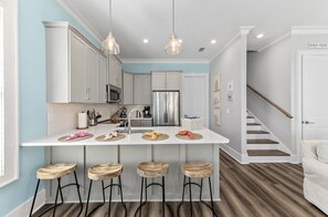 Enjoy cooking in this well-equipped kitchen with a central island and bar stools.
