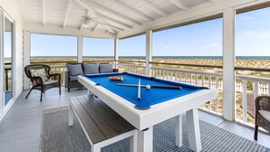 A pool table with a clear view of the beach through large windows. - Our most Popular Rental on Tybee! Voted best view! by Tybee Cottages (Tybee Island)